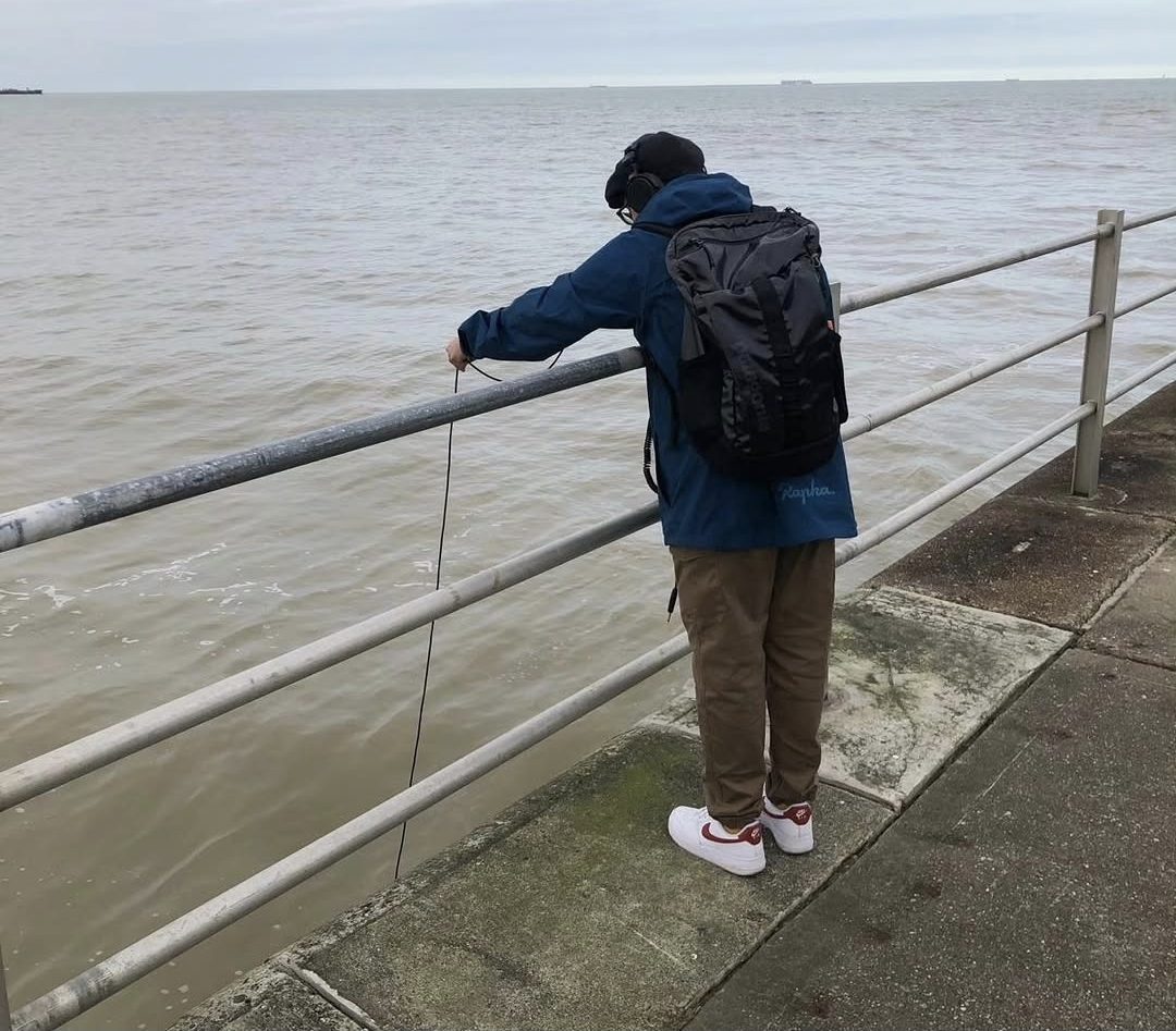 Recording the sea from a promenade railing