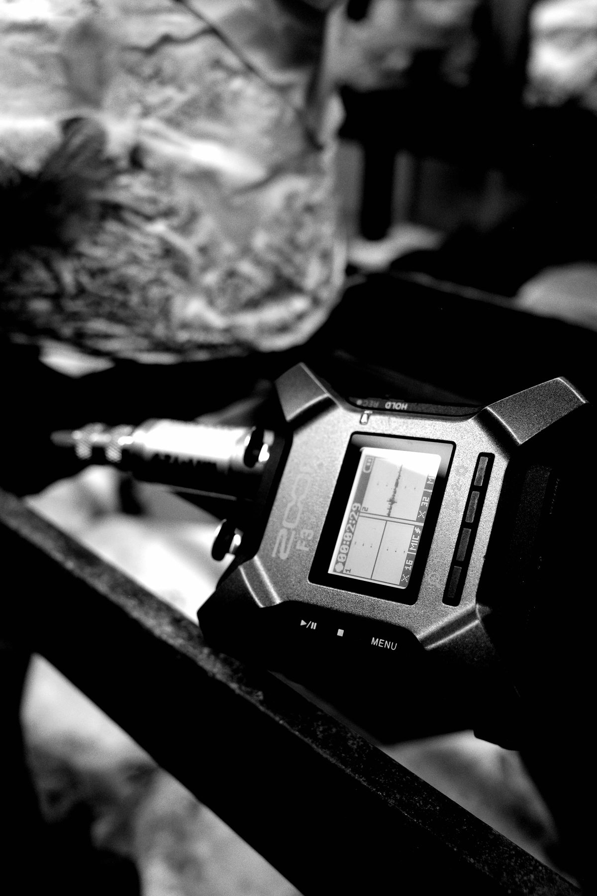 Close-up of a Zoom F3 field recorder mid-recording